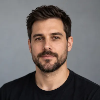 Portrait of James T. with short dark hair and a trimmed beard