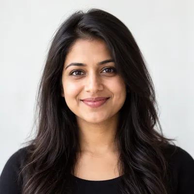 Portrait of Priya S. smiling, with long dark hair
