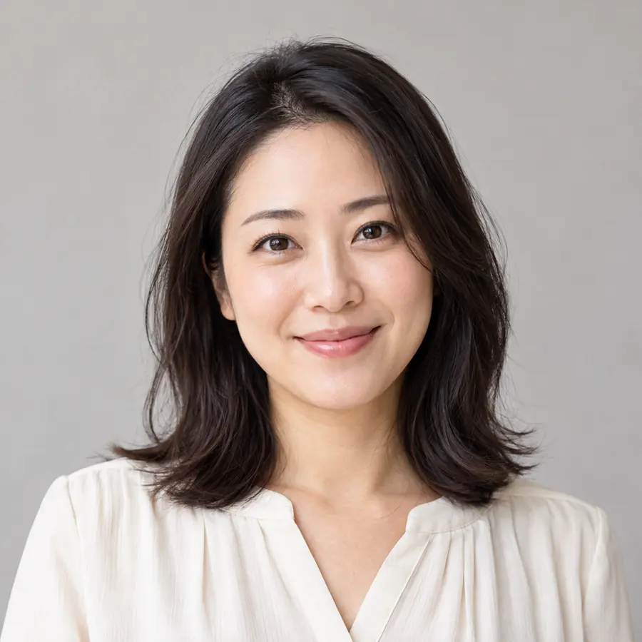 Portrait of Sarah Chen, smiling, with shoulder-length dark hair and a cream blouse