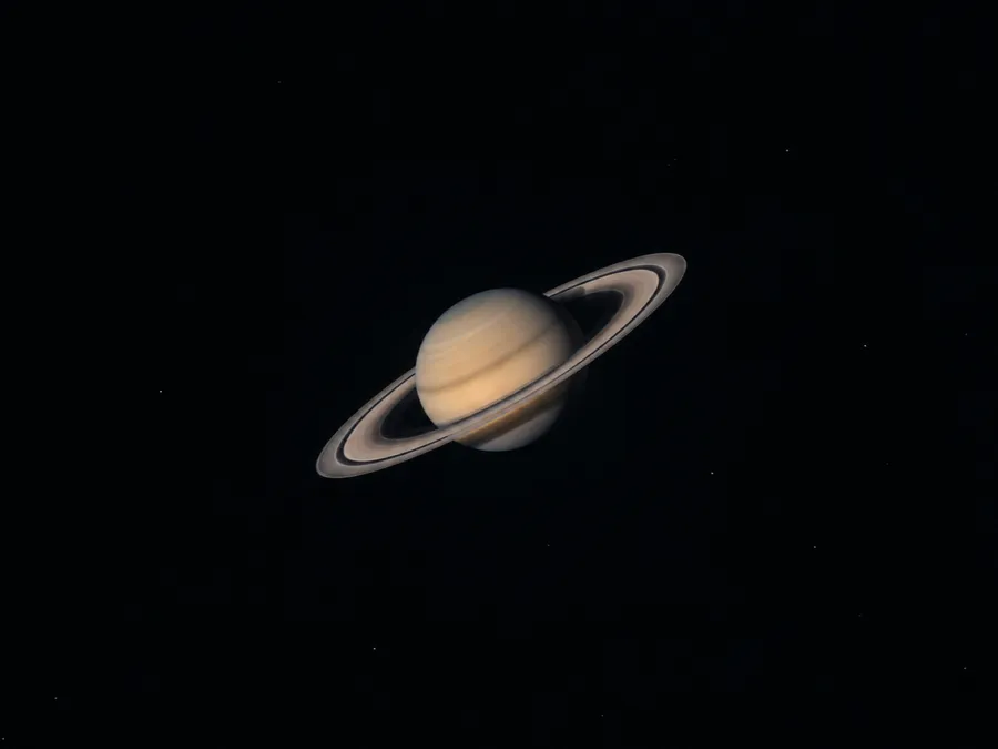 Saturn and its rings, small in a dark frame