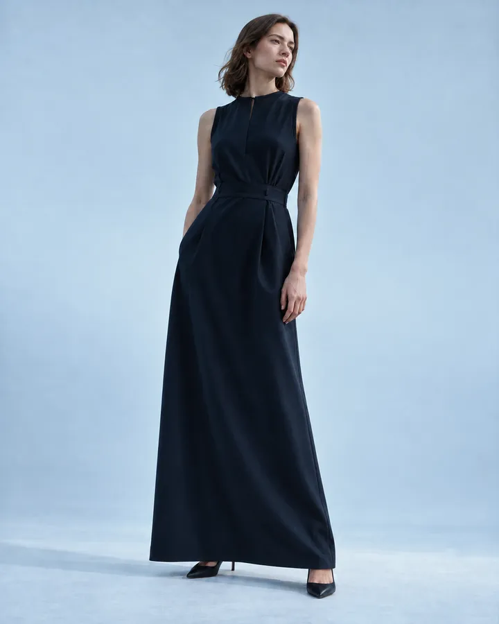 A woman in a sleeveless ink-navy column dress